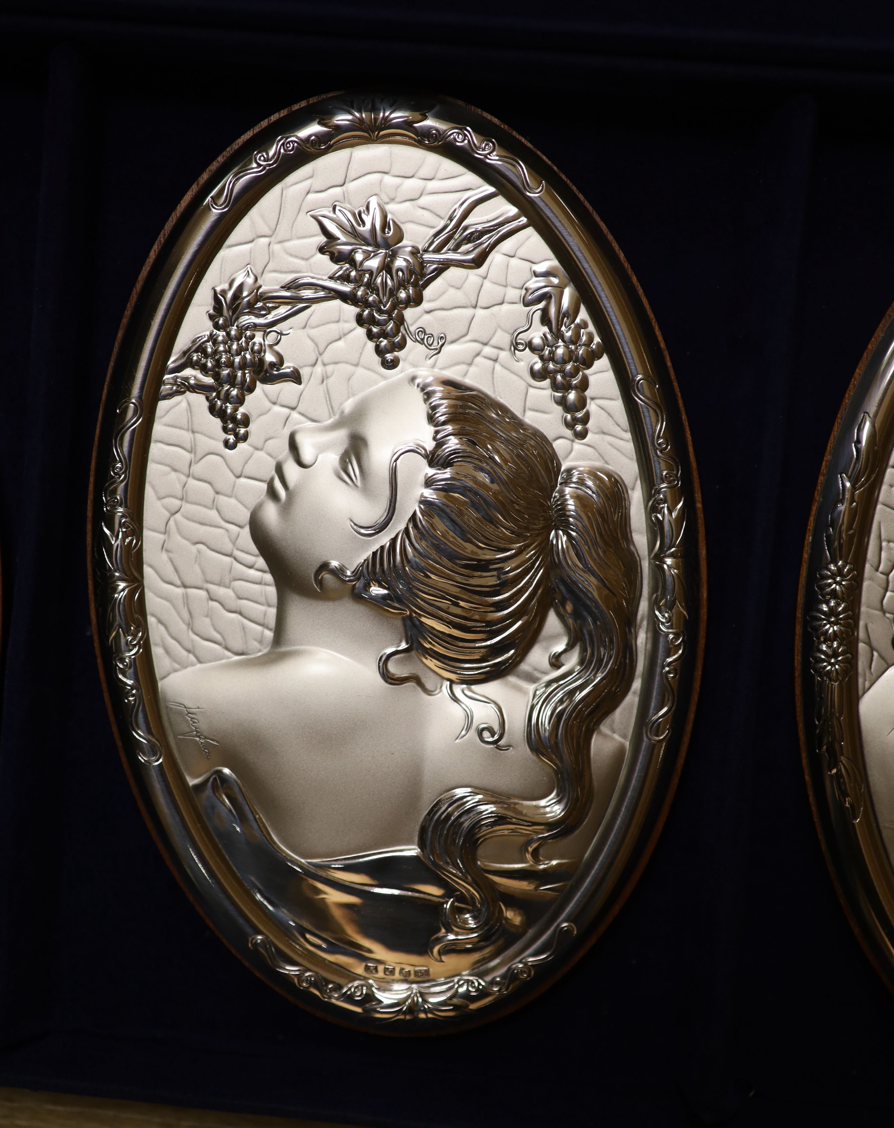 A cased set of four modern Italian repousse 850 white metal mounted 'The Four Seasons' wall plaques, 20.4cm.